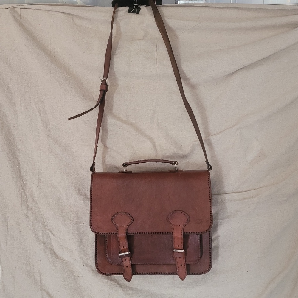 Leather tote or messenger bag. Leather handle and adjustable shoulder strap